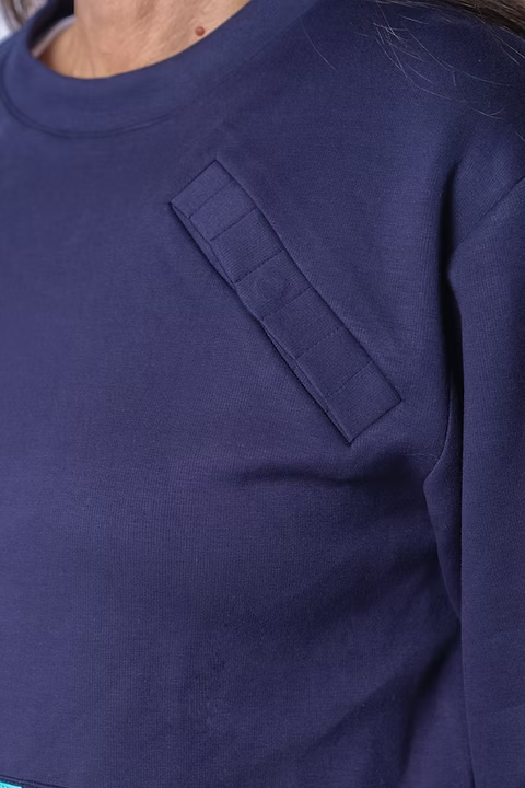 Close-up of the navy BCOMFY PortPocket sweatshirt magnetic access strip on the upper chest